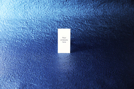 Close-up of a white card on a blue textured backgroundの写真素材