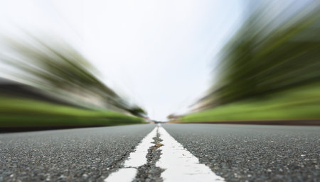 Asphalt road with white line in motion blur. Abstract background.の写真素材