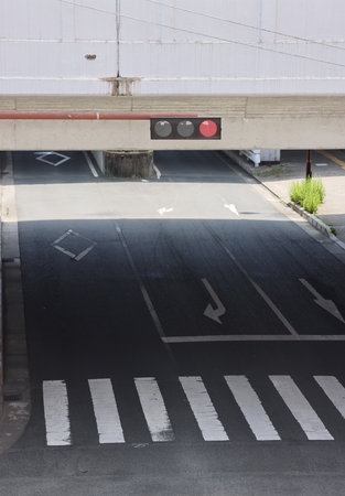 Crosswalk in the middle of the road with red traffic light.
