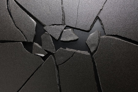 Pieces of broken ground on a black background. View from above.の写真素材