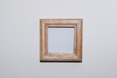 Wooden picture frame on a white wall. Wooden photo frame.の写真素材