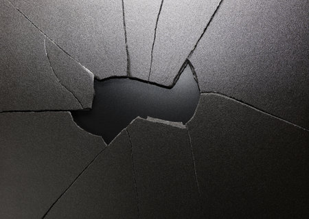 Broken hole in black ground with copy space for your text.の写真素材