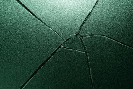 Cracked glass texture background in green tone. Abstract background and texture for design.の写真素材