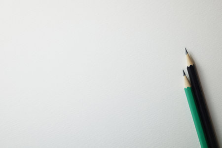 Pencils on white paper background with copy space for text.の写真素材