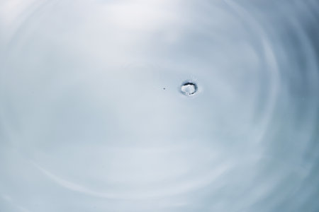 drop of water on the surface of the rippled water surfaceの写真素材