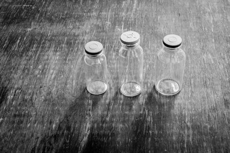Empty jars isolated on wood background. Black and whiteの写真素材