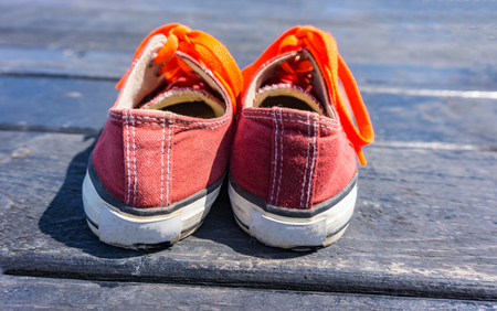 Orange shoes isolated on wood backgroundの写真素材