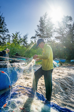 Man catching fishing on fishnetのeditorial素材