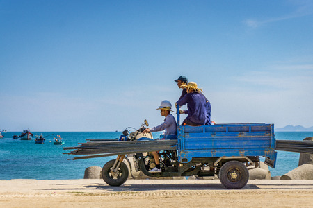 Three man driving vehicle in beachのeditorial素材