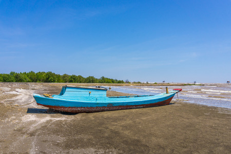 Wood fish ship on beachの写真素材