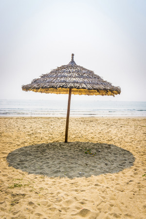 Straw umbrella in beachの写真素材