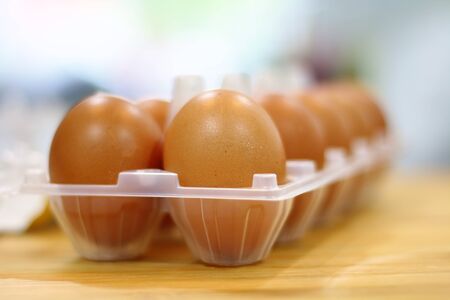 Chicken eggs on wooden kitchen table