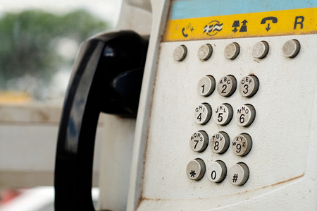 Close-up of the dial pad of an old public phone booth in Madagascar. Concept of old and outdated communicationの写真素材