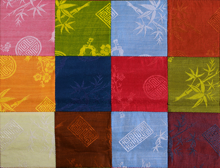 quilted fabric made from colorful square leftover fabricの写真素材