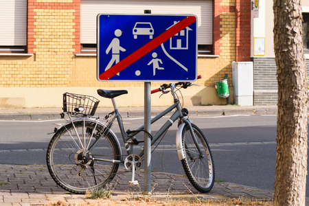 Bike parked on a end of playground street signのeditorial素材