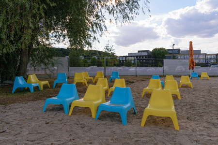 Blue and yellow plastic chairs in the beachの写真素材