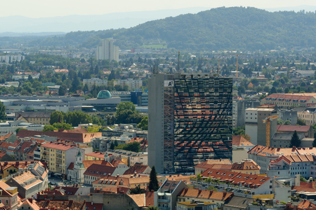Graz, Austria - August 28 2018: A view of the city of Graz, Austria, from the Uhrturm shows a tall modern building with reflection on its windowsのeditorial素材