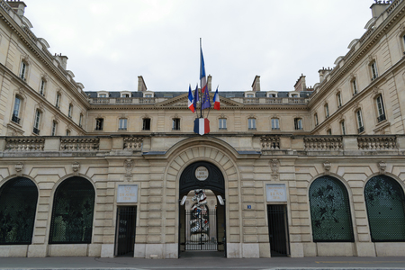 Paris, France - August 21, 2018: French and European flags standing at the entrance of the saving account bank in Paris, Franceのeditorial素材