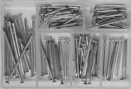 Close up of a bunch of nails in a nail boxの写真素材