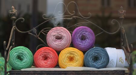 Colorful yarns on a vintage metal chair