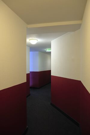 hallway with white and red wall and light onの写真素材