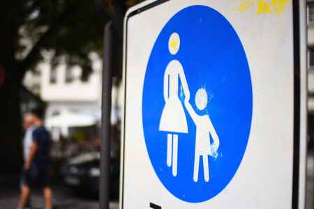 Pedestrian sign of woman with child in a blue circleの写真素材