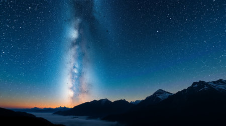 Milky way over mountains at night with stars
