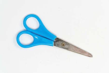 Blue scissors on a white background. View from above. Copy space.
