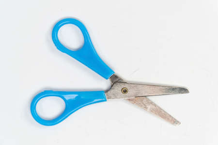 Blue scissor on white background. Flat lay, top view.の写真素材