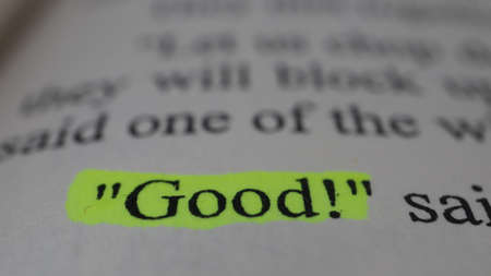 Good word printed on a book. Close-up. Selective focus.の写真素材