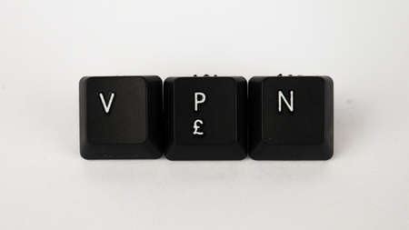 Computer keyboard keys spelling the word VPN, isolated on white background.