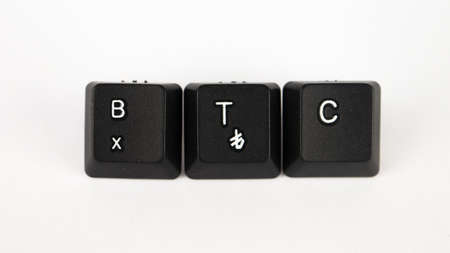 Black computer keyboard keys with the letters B, T, C