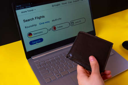 Close-up Of Person's Hand Inserting Credit Card Into Laptop
