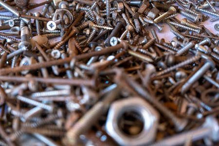 A closeup shot of a lot of screws with a shallow depth of field