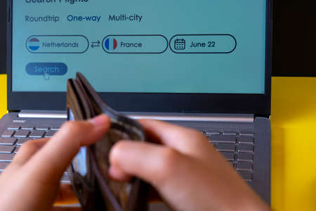 Close-up Of A Person's Hand Inserting Credit Card Into Laptop