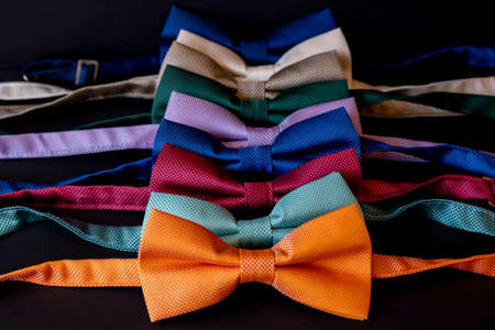 Multicolored bow ties on a black background close-up.の写真素材