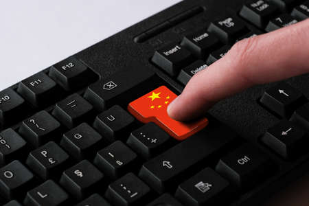 Finger Pressing Red Button Of Computer Keyboard With Flag Of Chinaの写真素材
