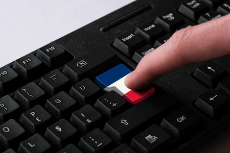 Computer keyboard with the flag of France, clicking on the enter buttonの写真素材