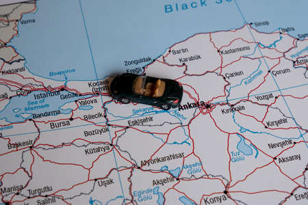 A miniature car on a map.の写真素材