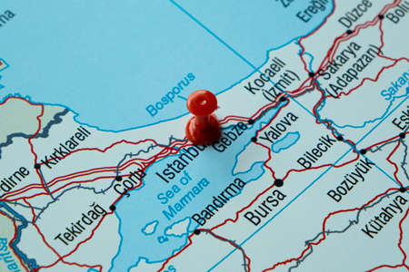 Red pushpin on a map. Close up