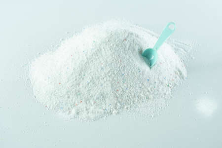 Pile of salt with measuring spoon on light background, closeupの写真素材