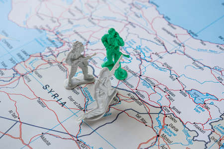 Miniature figures on a map. Selective focus.