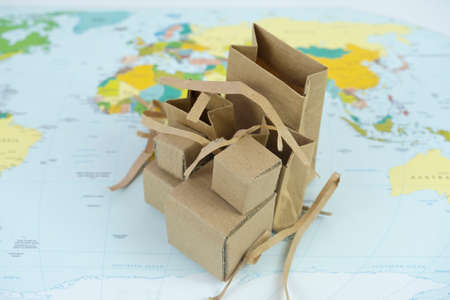 Cardboard box on the map of the world. Shipping concept.の写真素材