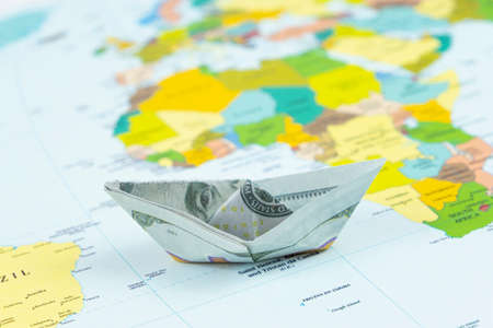 Paper boat on a map of Europe. Travel concept. Selective focus.