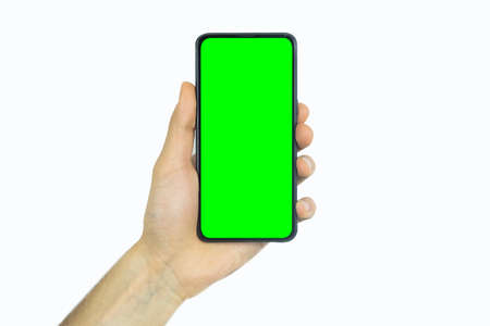 male hand holding a phone with a green screen on a white background