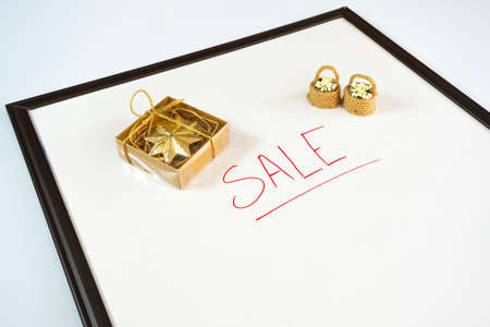 Sale concept. A gift box and a gold box on a white background.の写真素材