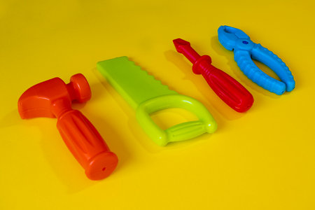 Colorful plastic toys for children on a yellow background. Top view.の写真素材