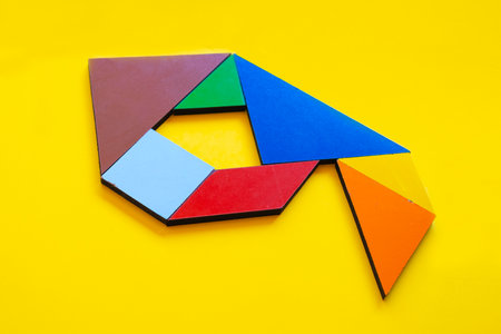Colorful tangram puzzle on yellow background