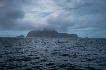 Arriving Malpelo island with thick clouds and rainの写真素材