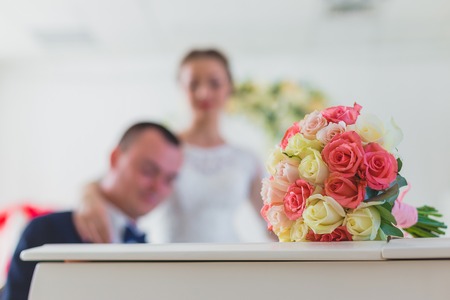 Wedding couple play on piano and bouquetの写真素材